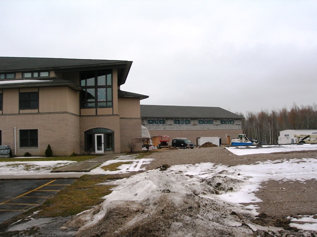 picture of rear elevation - the existing Church is in the foreground and the Addition is in the background - masonry, windows and roofing are installed