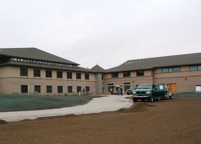 rear elevation picture of existing Church and Classroom Addition - shows finish grading and lawn seeding