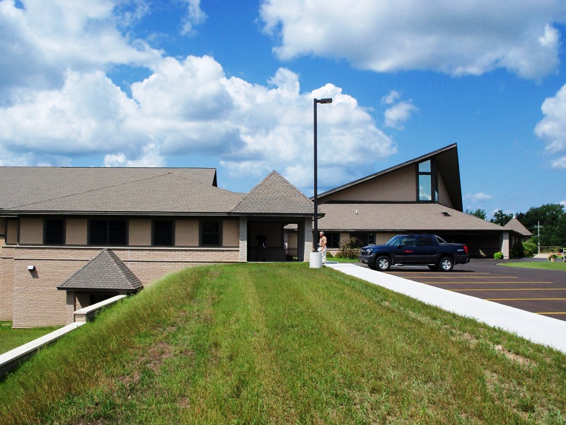 picture of front entrance of Classroom Addition at parking lot, lower level exit door visible at berm beside parking lot