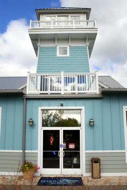 picture of Windjammer Marina in Alanson, Michigan - the observation tower and main entrance - light blue siding, white trim and grey metal roof