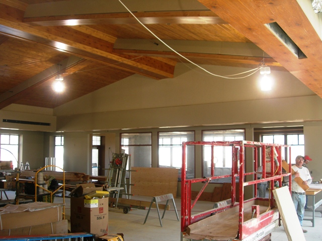 picture of interior of dining hall under construction with wood beam and plank ceiling