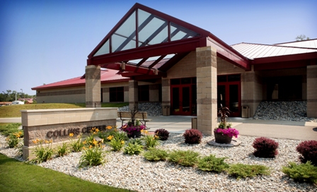 exterior picture of Collins Center Training Facility at Alpena Combat Readiness Training Center - picture taken on angle showing building sign in front of covered entry