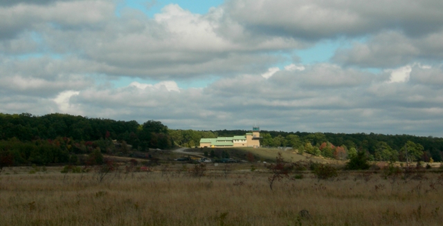 This picture of the Flank Tower Support Complex was taken on a Fall day from about a half-mile away.  The clouds broke a bit and allowed a ray of sun to fall on the building, illuminating it as though on purpose for this picture.