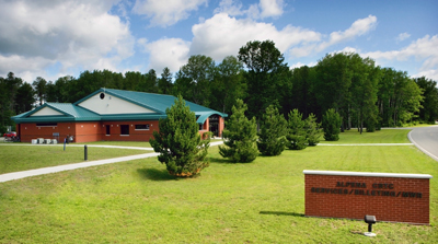 picture of Billeting Services and MWR accommodations for visiting units at Alpena Combat Readiness Training Center - red brick masonry walls with cream colored accents and blue/green metal roof