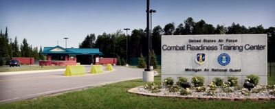 picture of Entry Gate at Alpena Combat Readiness Training Center - Base Signage in foreground, Guard House and Entry Gate in background