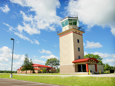 picture of Air Traffic Control Tower at Alpena Combat Readiness Training Center - Control Tower Entrance Canopy and airfield side elevation with Fire/Crash/Rescue Station in the background