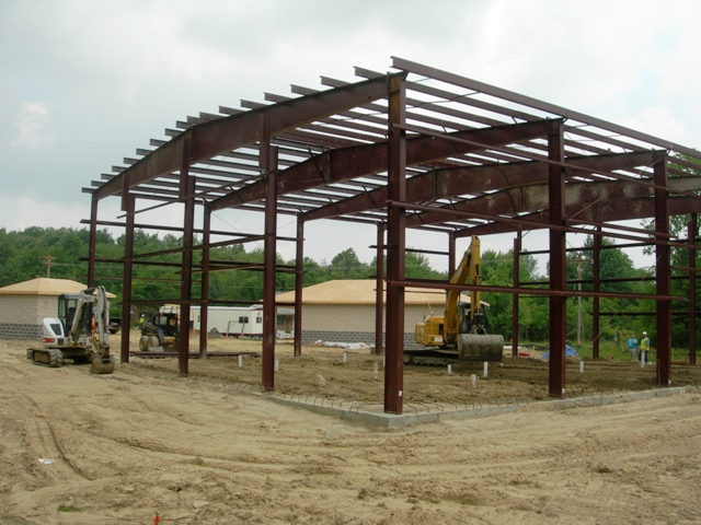 picture of structural steel framing with earthmoving equipment