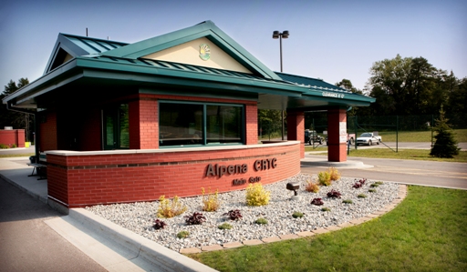 picture of Entry Gate Guard House at Alpena Combat Readiness Training Center - red masonry walls with blue-green metal roof