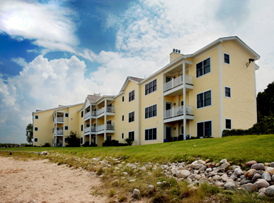 photo of Multi-Family Residential Development - Harborage Pointe Waterfront Condominiums in East Jordan, Michigan - picture of the lakeside elevation taken while standing on the beach