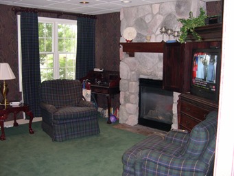 interior photo of Newberry Assisted Living Facility - television room with fire place