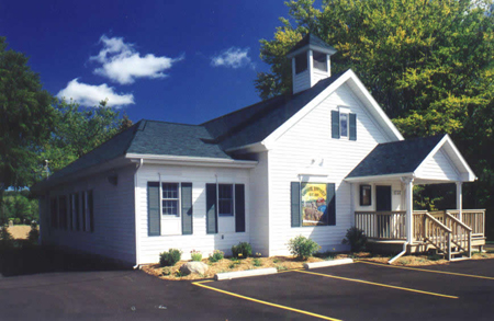 picture of Chester Township Hall in Gaylord MI - historic schoolhouse converted to township hall - white siding, black trim and black shingle roof