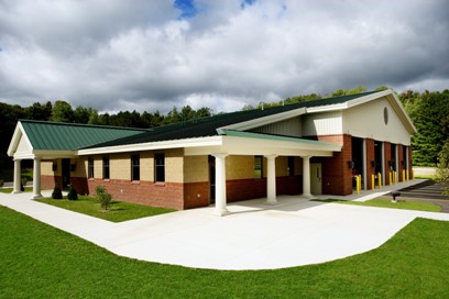 picture of Littlefield Fire Station in Alanson, Michigan - angled photo showing front entrance, side entrance and Apparatus Bay