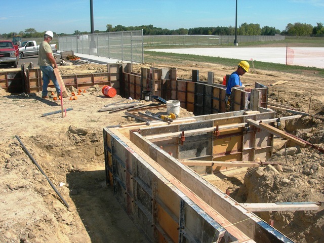 workmen placing concrete forms for new construction
