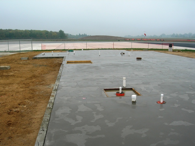poured concrete slab shows footprint of new building at OZW Airport