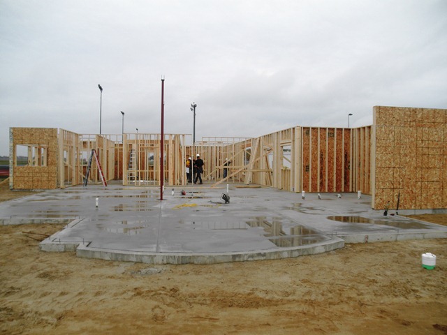 poured concrete slab with beginnings of wall framing