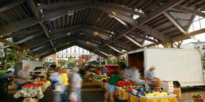 picture of Pavilion on Court Street in Gaylord, Michigan during Farmer's Market with tables set up full of produce being sold to customers