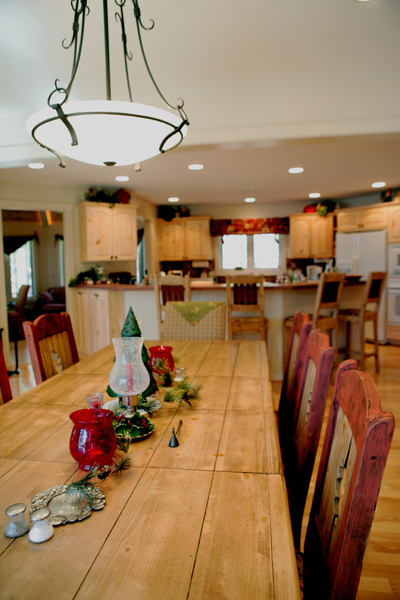 picture of lakefront home - this interior photo is taken in the dining room, looking toward the gourmet kitchen with generous central island, recessed lighting and custom cabinets