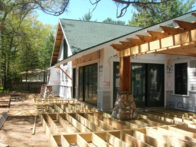 Lake Margrethe custom home lakeside elevation pergola and deck under construction