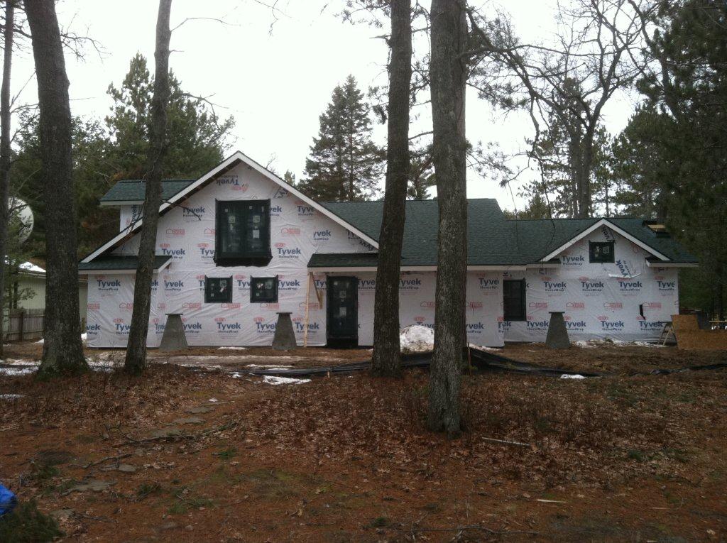 house wrap installed on Lake Margrethe custom home with windows, doors and green roof