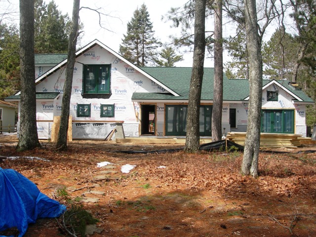 Lake Margrethe custom home with green custom windows, doors and green roof