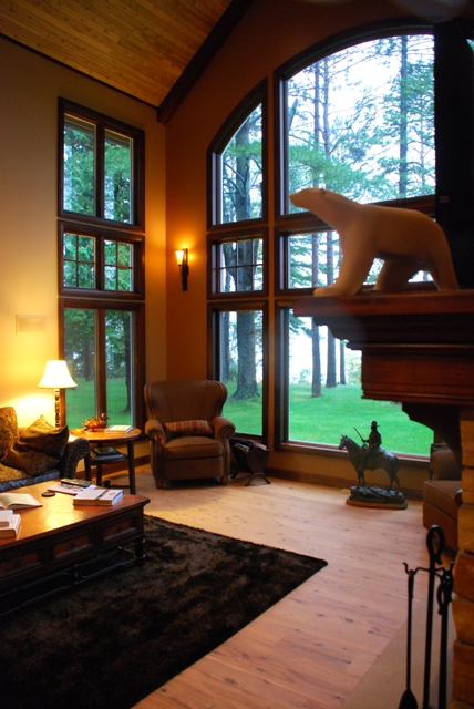 interior photo of Great Room of lakefront home in Lewiston, Michigan - arched ceiling showcases custom windows looking out on West Twin Lake