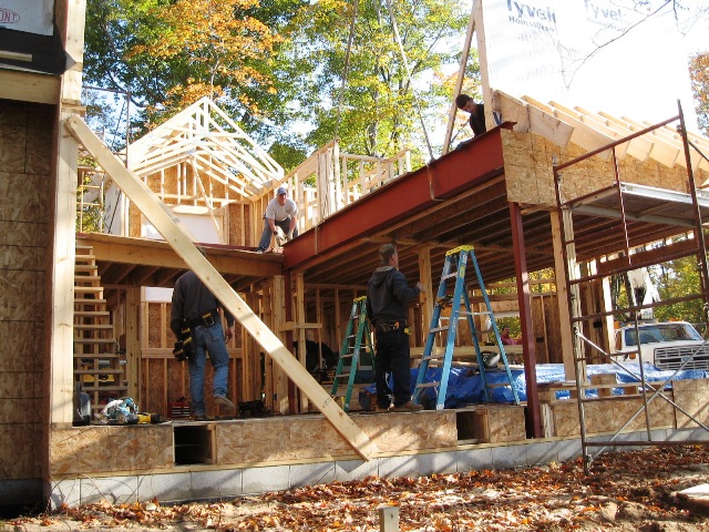 picture of construction workers setting steel beam