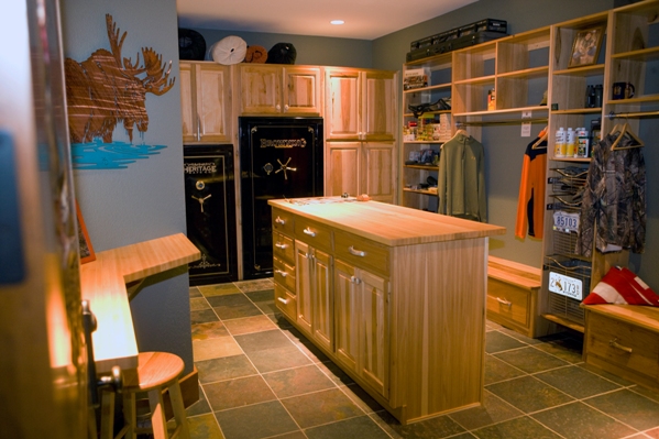 photo of the hunters' prep room with gun safes and dressing area with quarry tile floors and custom cabinetry