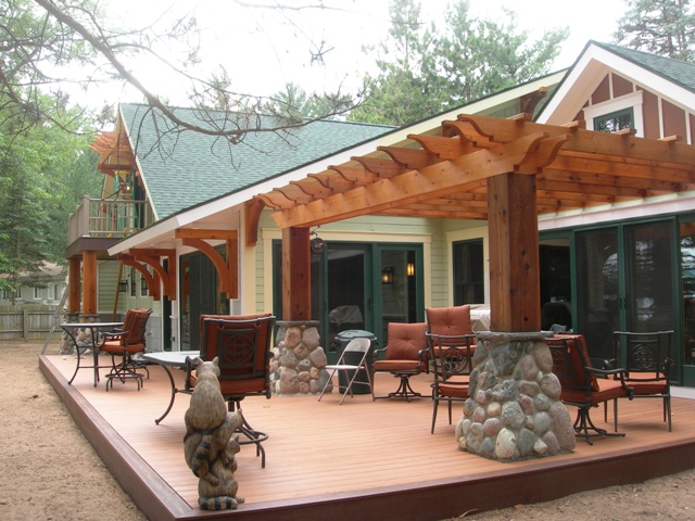 Lake Margrethe custom home lakeside exterior, green and grey siding, white trim and fieldstone accents